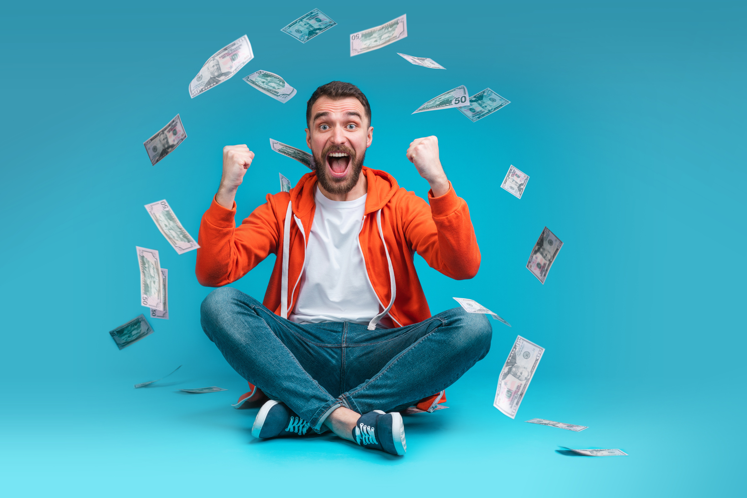 Lucky man celebrating money win after betting online at bookmaker's website